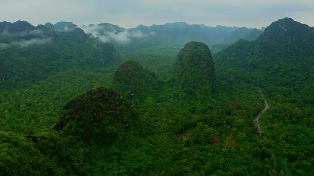 Aerial view of mountain landscape with low clouds and fog in Haiphong state, Vietnam.