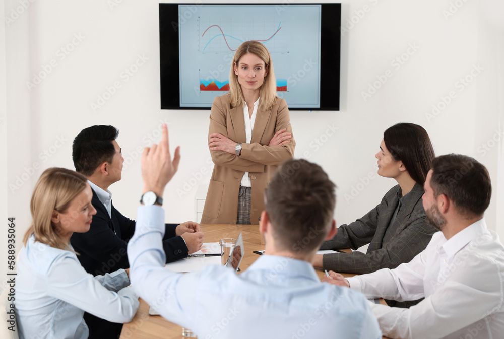 Poster Businesswoman having meeting with her employees in office