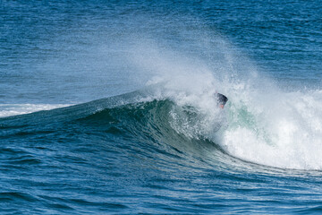 Bodyboarder surfing ocean wave