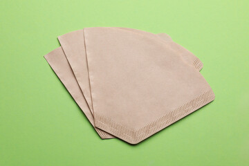 Paper coffee filters on green background, flat lay
