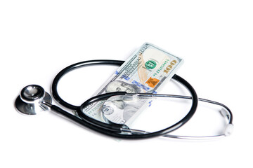 money dollars for medicine expenses in selective focus. stethoscope of medicine expenses