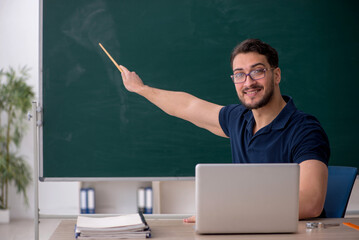 Young male teacher in telestudying concept