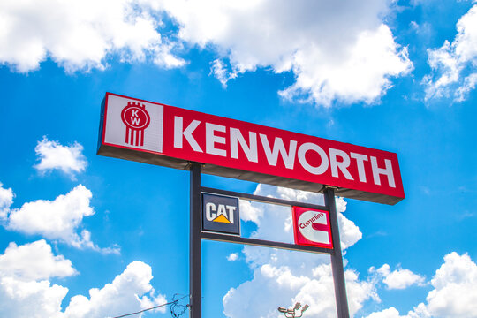 Kenworth sky sign with a blue sky and clouds