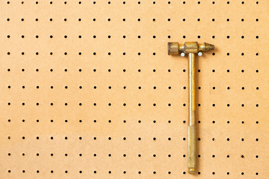 hand tools on a workshop peg board. - Powered by Adobe
