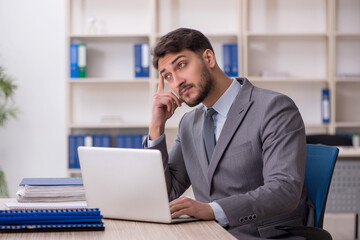 Young male employee working in the office