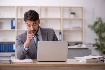 Young male employee working in the office