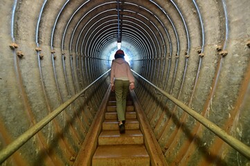 Person ascending an underground tunnel