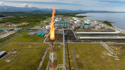 Gas flare on major industrial complex and oil refinery. Oil terminal is industrial facility for...