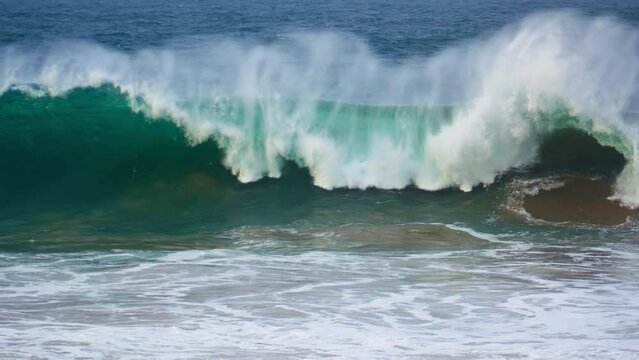 Huge ocean surf barrelling in super slow motion. Powerful wave rolling breaking