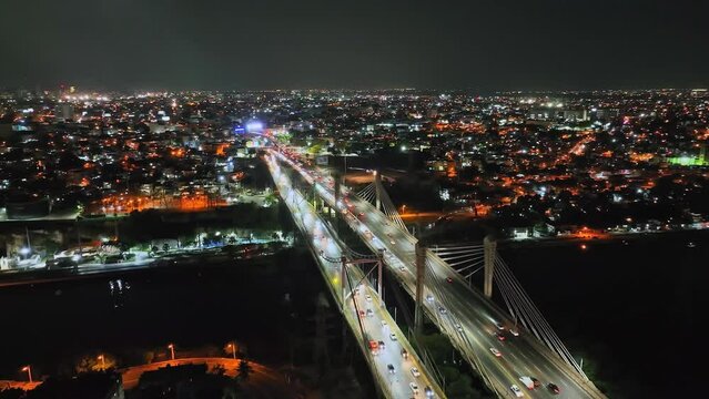Scenic View Of Puente Prof. Juan Bosch And Puente Juan Pablo Duarte At Night In Santo Domingo, Dominican Republic. Aerial Wide Shot