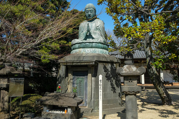 Fototapeta premium Tokyo, Japan - March 3, 2023: Bronze Buddha statue constructed in 1690 by Ota Kyuemon known as 