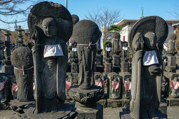 Tokyo, Japan - March 3, 2023: Stone statues of Jizo, the patron deity of children and travelers, in Jomyoin Temple located at Ueno Park in Tokyo, Japan.