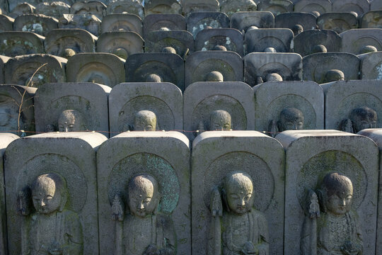 Tokyo, Japan - March 3, 2023: Stone statues of Jizo, the patron deity of children and travelers, in Jomyoin Temple located at Ueno Park in Tokyo, Japan.