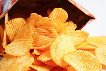 Potato chips in open bag, delicious BBQ seasoning spicy for crips, thin slice deep fried snack fast food.
