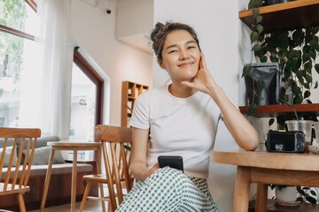 Happy lovely asian girl relaxing in the cafe. Concept of happy single life.