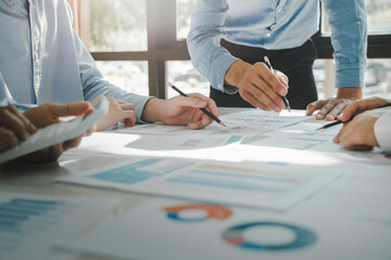 Businessmen working together at desk.