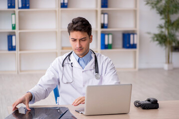 Young male doctor radiologist working in the clinic