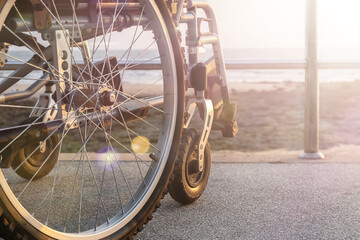 A wheelchair stands on the seafront