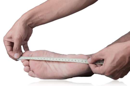 Close-up of a man measuring foot size with a measuring tape on a clipping path white background