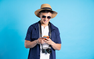 travel asian man portrait, isolated on blue background