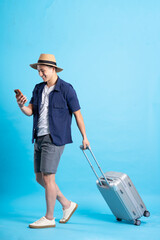 travel asian man portrait, isolated on blue background