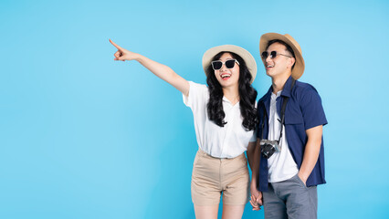 Asian couple traveling image  isolated on blue background