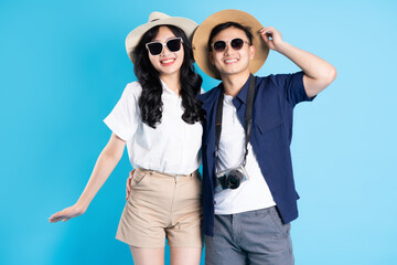 Asian couple traveling image  isolated on blue background