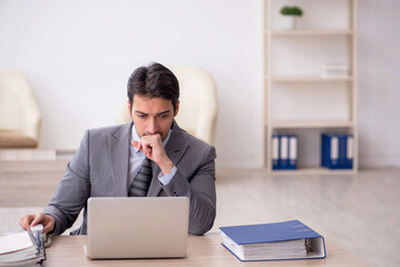 Young male employee working in the office