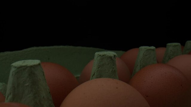 Full cartage of raw fresh eggs in domestic kitchen, macro close up view probe lens