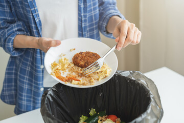 Compost from leftover food, refuse asian young housekeeper woman, girl hand using fork scraping waste from dish, throwing away putting into garbage, trash or bin..Environmentally responsible, ecology.