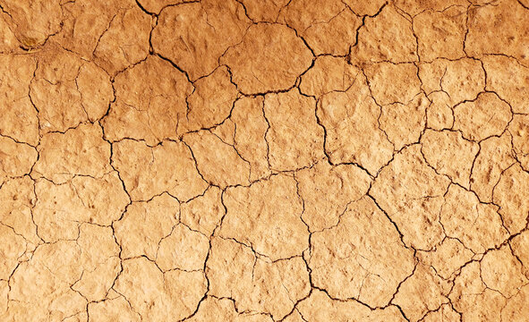 Cracked ground background in the top view for graphic design or wallpaper