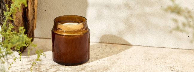 Aesthetic composition with aromatic candle in jar. Mockup soy wax candle in natural style. Scented...