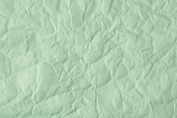 Recycled crumpled turquoise paper texture or paper background for design with copy space for text or image