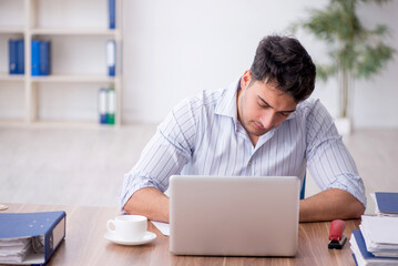 Young male employee working in the office