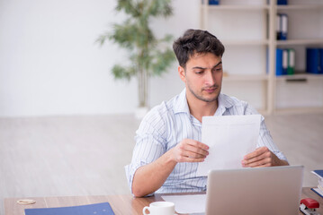 Young male employee working in the office