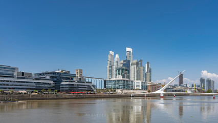 The city quarter of Puerto Madero Buenos Aires. Above the river is a beautiful swing Women bridge -...