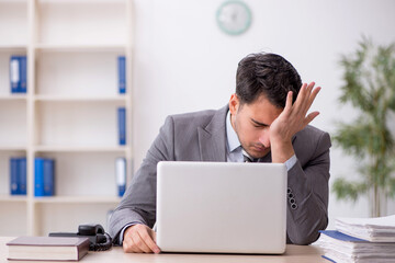 Young male employee working in the office