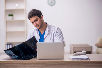 Young doctor radiologist sitting at the hospital