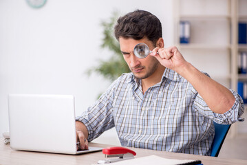 Young male employee working in the office
