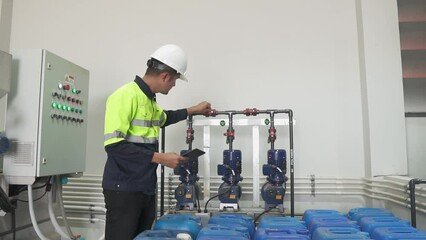 Asian young industrial engineer Control chemical systems and utility water system sewers and wastewater treatment plants. 