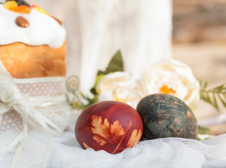 Easter eggs and Easter bread decorated with candied fruit on a wooden background. Close-up. Selective focus.