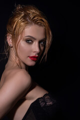 Fototapeta premium Fashion portrait of beautiful young model in studio. Fashionable woman with beauty face, soft skin, natural makeup, romantic look. Charming sexy sensual beautiful woman face close up.