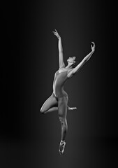 Fototapeta na wymiar Young ballerina in pointe shoes dancing. Black and white effect