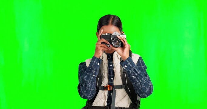 Travel, green screen and woman camera in a studio for camping and outdoor adventure. Traveling backpack, nature photography and happy female with walking gear for vacation journey with happiness