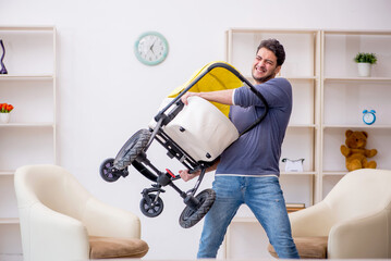 Young man looking after newborn at home