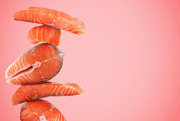 Cut fresh salmon on pink background, space for text