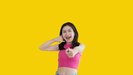 Call sign, Bright young asian woman inviting to call isolated on yellow background, Suggest to call or invite to apply for membership, Isolated on yellow background...