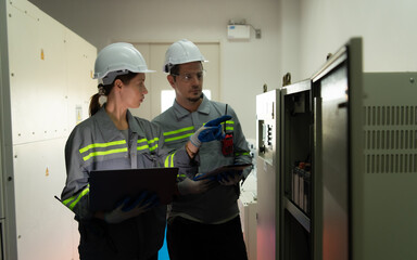 Electric power engineering team inspecting system of a large solar energy storage station in the...