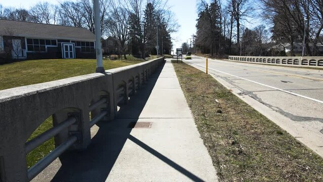 Traffic on a local cement and stone bridge.