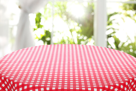 Red And White Checkered Tablecloth On Table Near Window. Space For Text